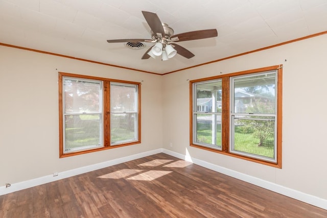 3012 Berry Ave, Groves, TX 77619 - empty room with dark wood finished floors, ornamental molding, and ceiling fan