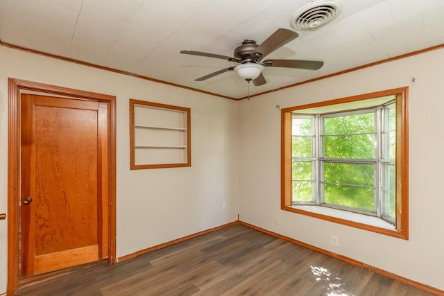 3012 Berry Ave, Groves, TX 77619 - empty room with wood finished floors, built in features, a ceiling fan, and ornamental molding
