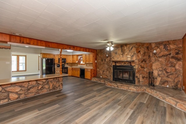 3012 Berry Ave, Groves, TX 77619 - unfurnished living room featuring a ceiling fan, a fireplace, and dark wood-style flooring