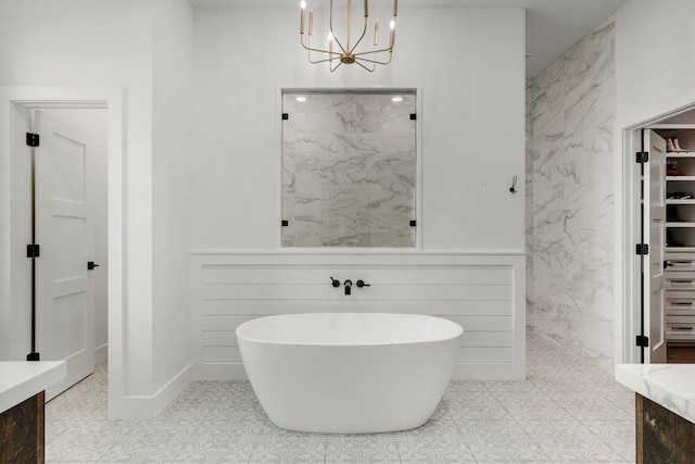 bathroom featuring tile patterned floors, vanity, independent shower and bath, and a notable chandelier