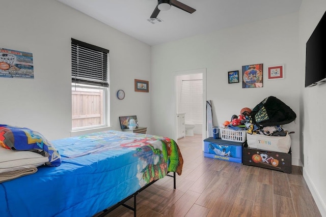 bedroom with wood-type flooring, connected bathroom, and ceiling fan