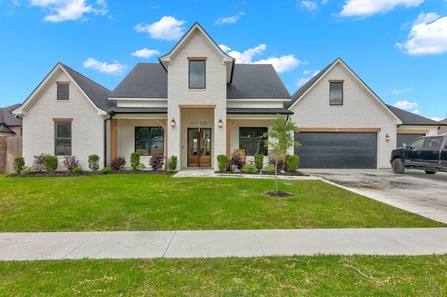 view of front of home featuring a front lawn, a garage, and french doors