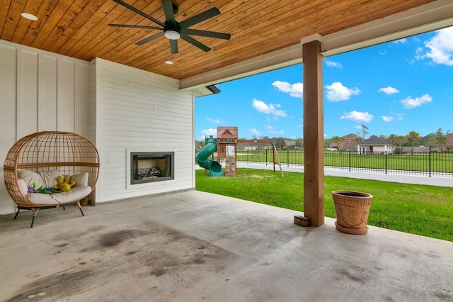 view of patio featuring a playground and ceiling fan