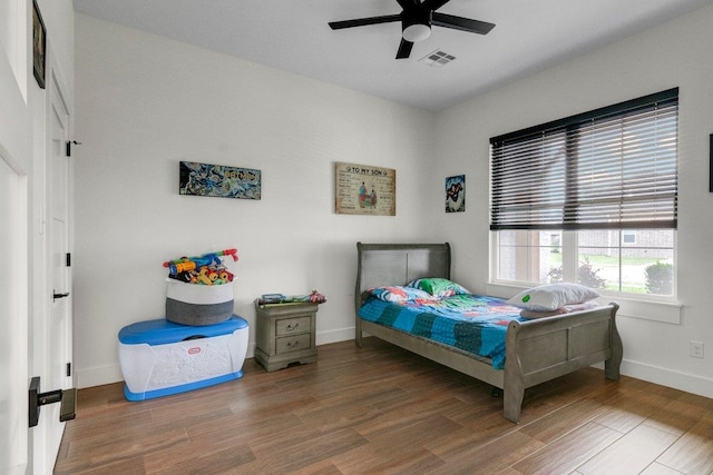 bedroom with ceiling fan and dark hardwood / wood-style flooring