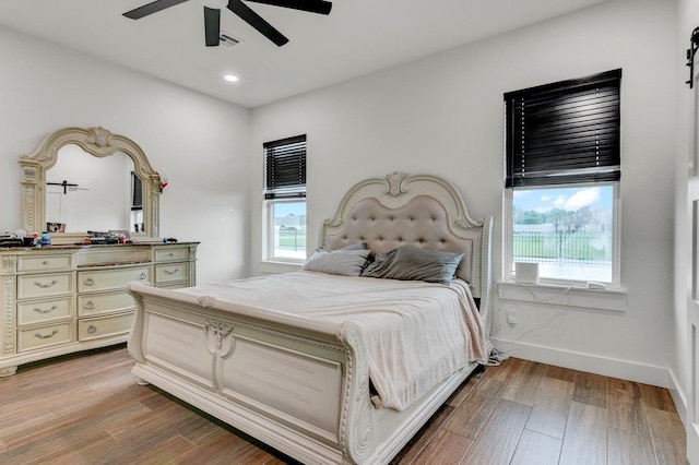 bedroom with hardwood / wood-style floors and ceiling fan