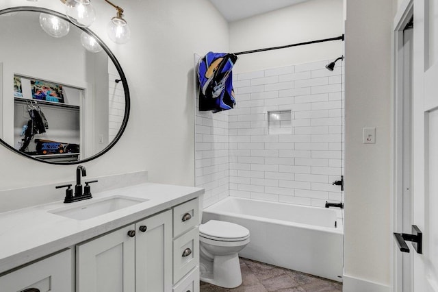 full bathroom featuring vanity, toilet, and tiled shower / bath combo