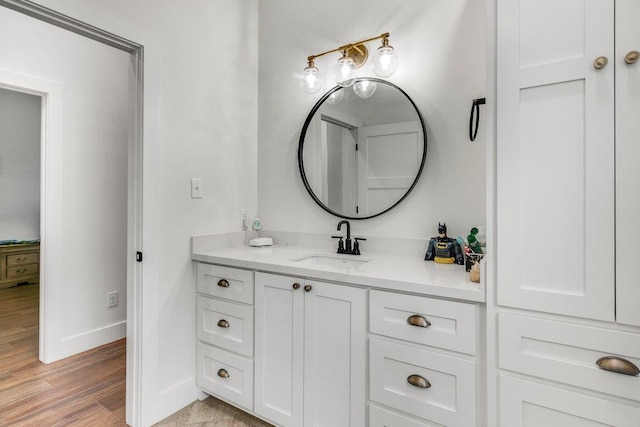 bathroom with hardwood / wood-style floors and vanity