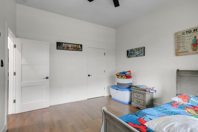 bedroom with hardwood / wood-style floors and ceiling fan