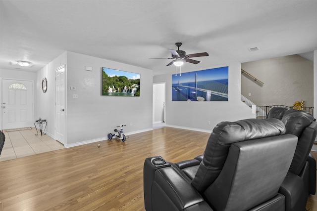 10393 Duncan Rd, Beaumont, TX 77713 - living area with ceiling fan, light wood-type flooring, and stairway