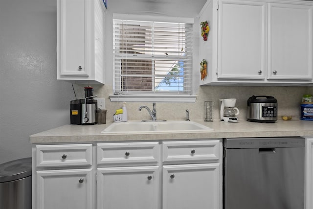 10393 Duncan Rd, Beaumont, TX 77713 - kitchen with dishwasher, light countertops, white cabinetry, and a textured wall