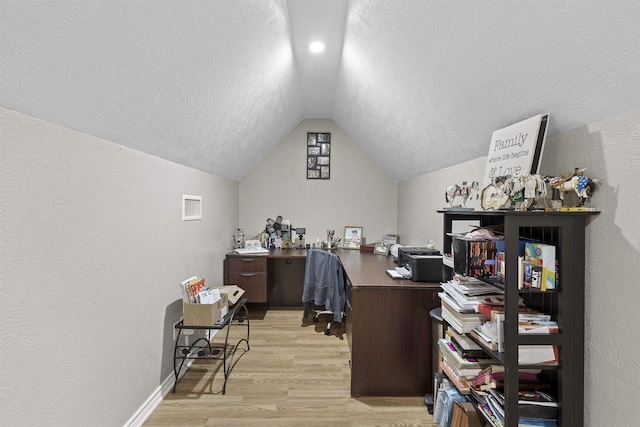 10393 Duncan Rd, Beaumont, TX 77713 - office area with vaulted ceiling, light wood-style flooring, a textured ceiling, and a textured wall