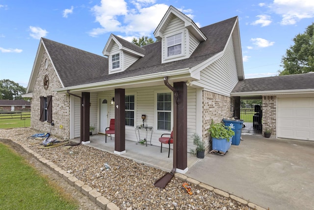 10393 Duncan Rd, Beaumont, TX 77713 - view of front of property featuring a porch, brick siding, concrete driveway, and a shingled roof