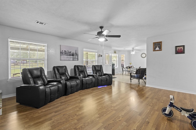 10393 Duncan Rd, Beaumont, TX 77713 - cinema room with ceiling fan, wood finished floors, and a textured ceiling