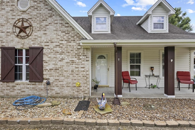 10393 Duncan Rd, Beaumont, TX 77713 - view of front facade featuring covered porch, brick siding, and roof with shingles