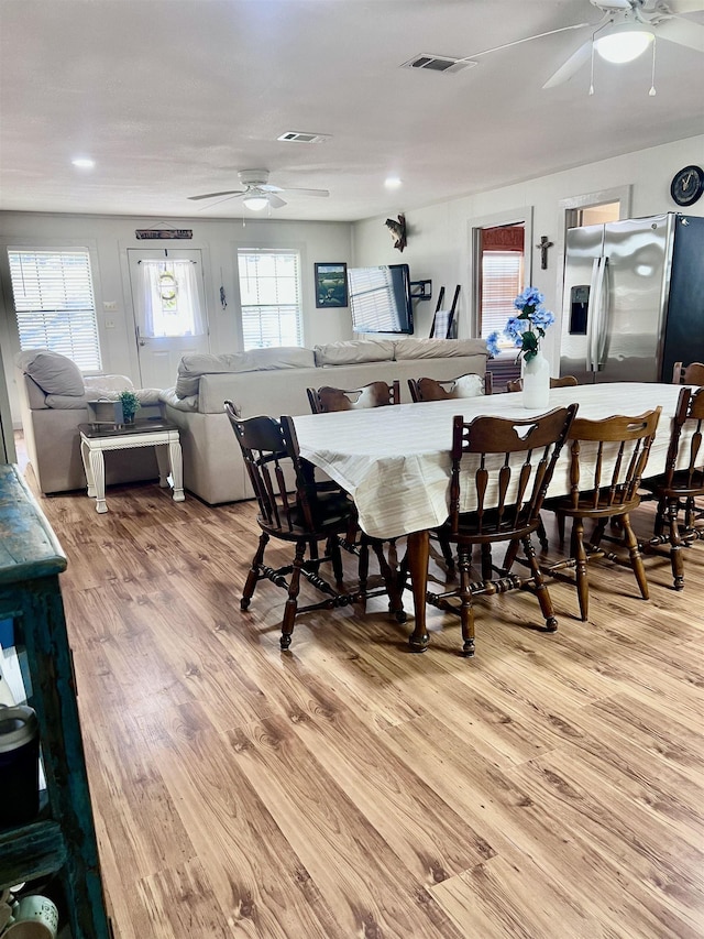 dining area with a ceiling fan, visible vents, and light wood-style flooring