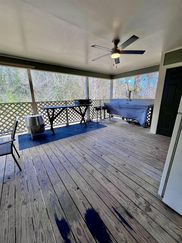 wooden terrace with a ceiling fan