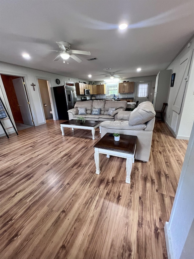 living area featuring light wood-style floors, visible vents, a ceiling fan, and recessed lighting