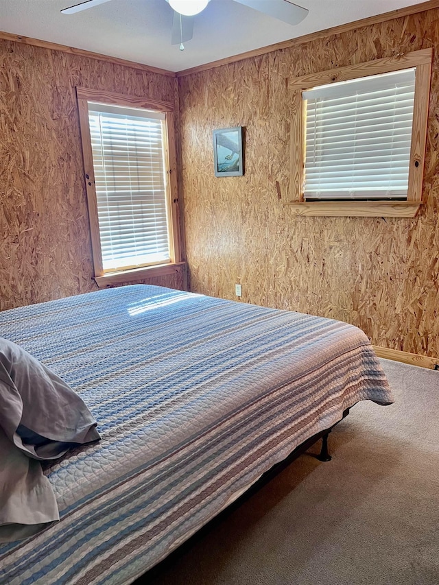 bedroom with carpet, crown molding, baseboards, and a ceiling fan