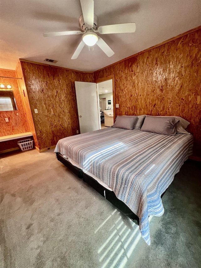 unfurnished bedroom featuring visible vents, crown molding, carpet flooring, and ceiling fan