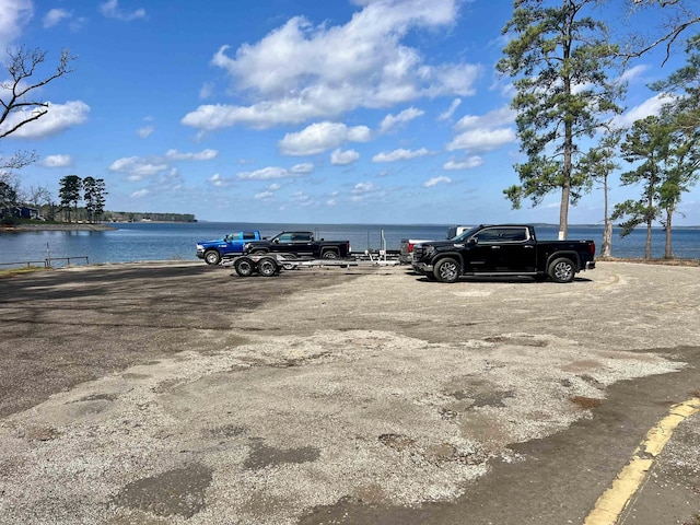 uncovered parking lot with a water view