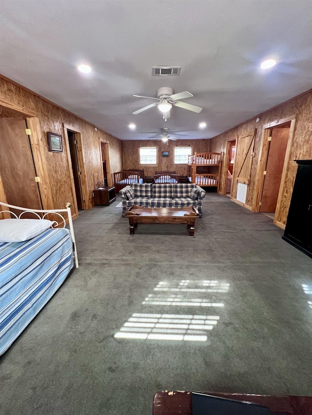 unfurnished bedroom with carpet floors, wooden walls, visible vents, and recessed lighting