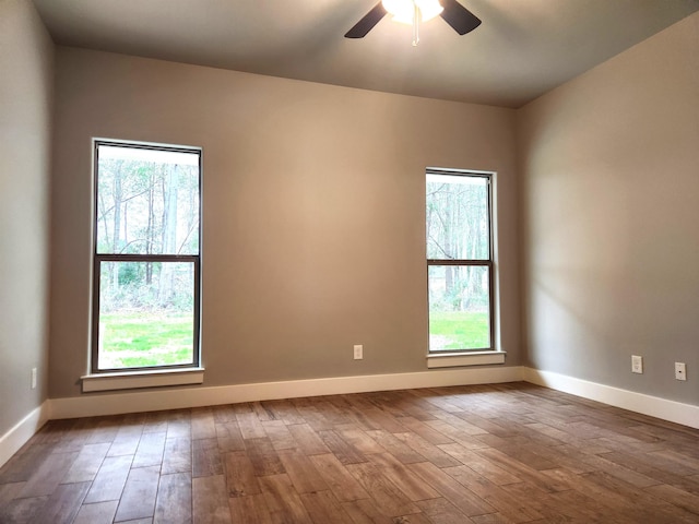 spare room with wood-type flooring, plenty of natural light, and ceiling fan