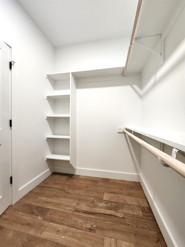 spacious closet featuring hardwood / wood-style flooring