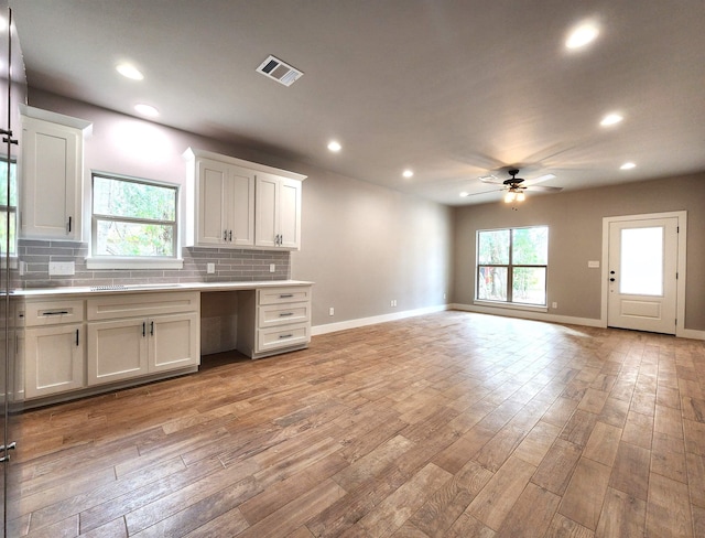 kitchen featuring white cabinetry, ceiling fan, light hardwood / wood-style flooring, and plenty of natural light