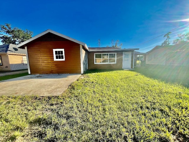 rear view of property featuring a yard