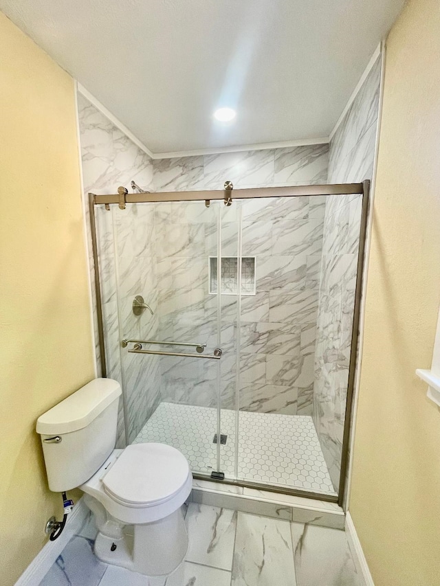 bathroom featuring toilet and an enclosed shower