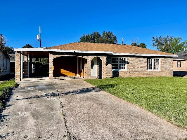 ranch-style home with a front yard and a carport