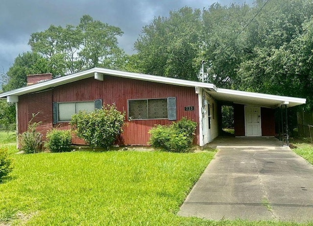 733 Phyllis Ave, Port Arthur, TX 77640 - single story home featuring driveway, a chimney, a front yard, and an attached carport