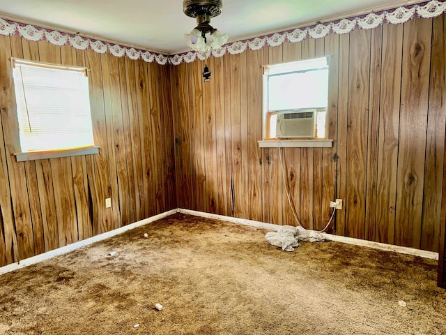 733 Phyllis Ave, Port Arthur, TX 77640 - spare room with cooling unit, carpet, wooden walls, and ceiling fan