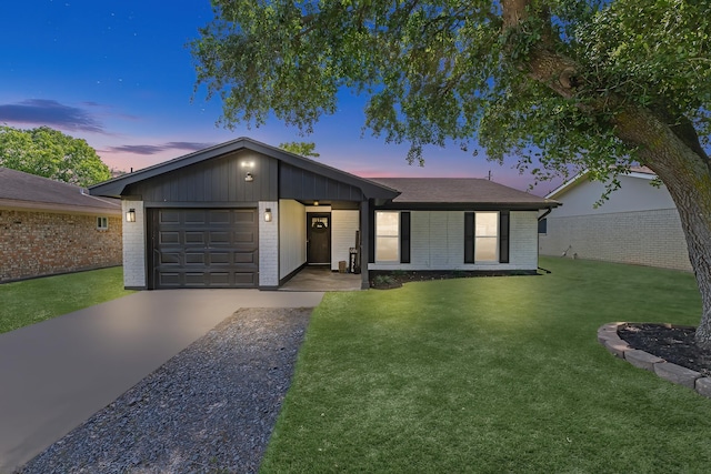 1432 W Palm Dr, Winnie, TX 77665 - ranch-style home featuring brick siding, a garage, concrete driveway, and a yard