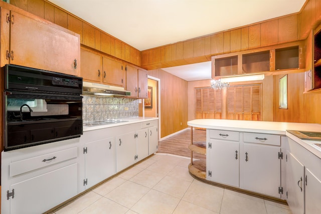 kitchen featuring white cabinets, a chandelier, oven, and electric stovetop