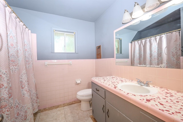 bathroom featuring vanity, tile patterned flooring, a shower with shower curtain, toilet, and tile walls