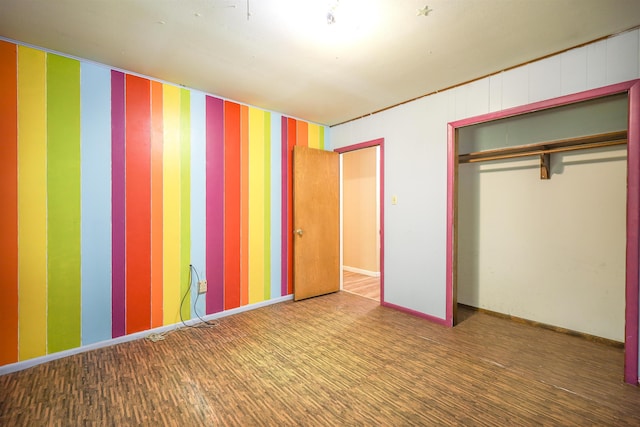 unfurnished bedroom with wood-type flooring and a closet