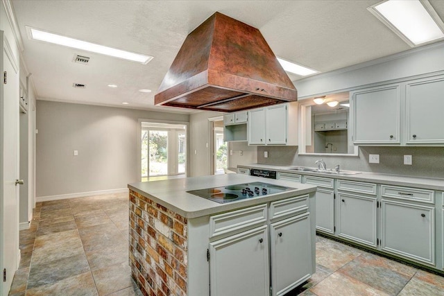 6325 Gladys Ave, Beaumont, TX 77706 - kitchen with black electric stovetop, island range hood, a center island, light countertops, and dishwasher