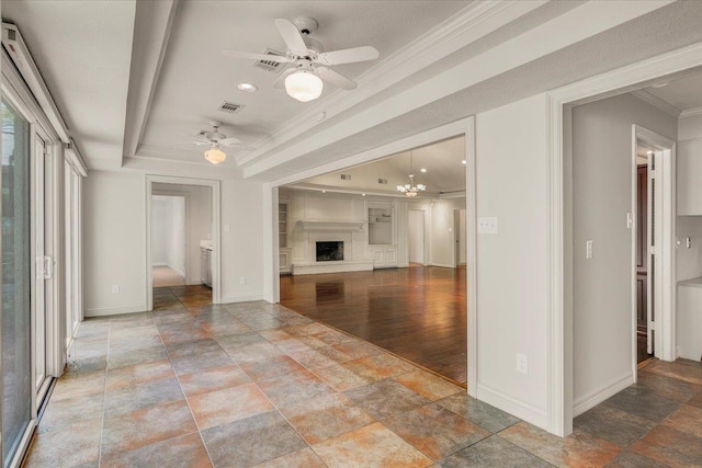 6325 Gladys Ave, Beaumont, TX 77706 - unfurnished living room with stone finish flooring, ornamental molding, a ceiling fan, a tray ceiling, and a fireplace with raised hearth