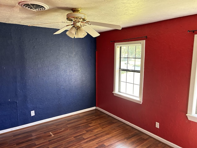 unfurnished room featuring a textured ceiling, dark hardwood / wood-style floors, and ceiling fan