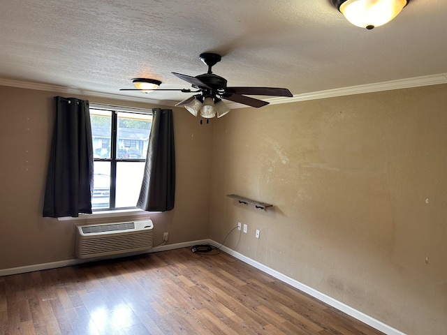 spare room with hardwood / wood-style floors, a wall mounted AC, crown molding, and ceiling fan