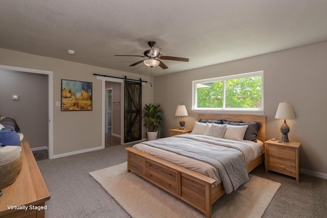 319 Pinemont Dr, Beaumont, TX 77659 - bedroom with carpet floors, a ceiling fan, baseboards, and a barn door