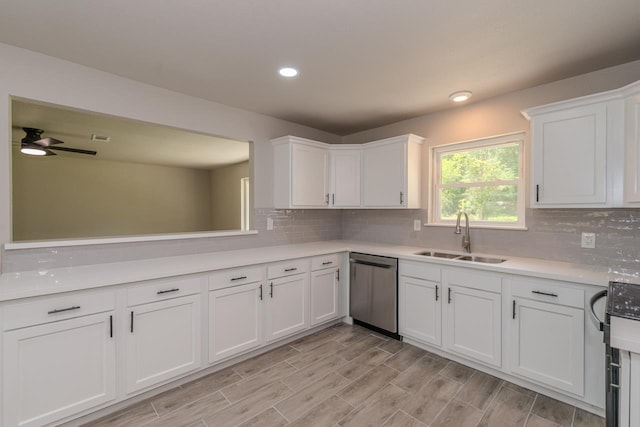 319 Pinemont Dr, Beaumont, TX 77659 - kitchen featuring white cabinets, a sink, light countertops, decorative backsplash, and stainless steel dishwasher