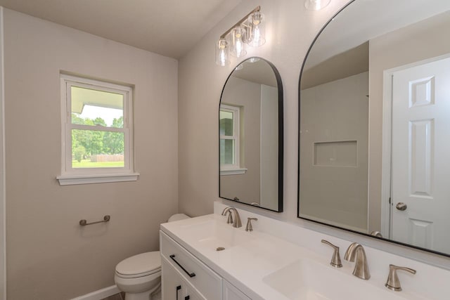 319 Pinemont Dr, Beaumont, TX 77659 - bathroom featuring baseboards, a sink, double vanity, and toilet