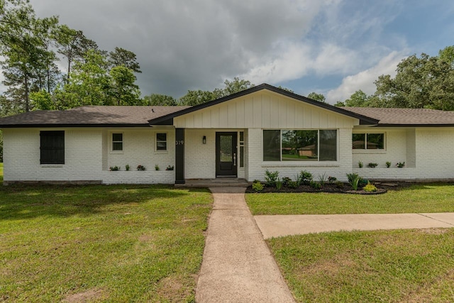 319 Pinemont Dr, Beaumont, TX 77659 - single story home featuring a shingled roof, a front yard, and brick siding