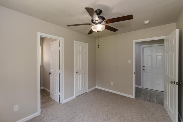 319 Pinemont Dr, Beaumont, TX 77659 - unfurnished bedroom featuring baseboards, carpet, and a ceiling fan