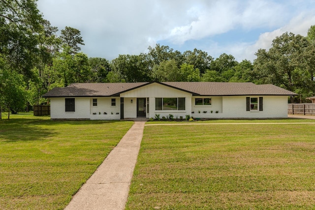 319 Pinemont Dr, Beaumont, TX 77659 - view of front of home with brick siding, fence, and a front yard