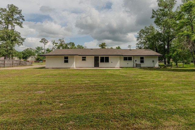 319 Pinemont Dr, Beaumont, TX 77659 - rear view of house featuring a yard, fence, and a patio area