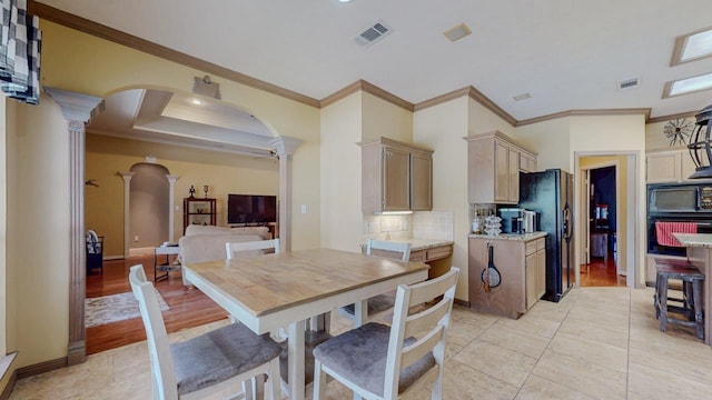 7640 Merion Dr, Beaumont, TX 77707 - dining area featuring decorative columns, crown molding, arched walkways, light tile patterned floors, and a ceiling fan