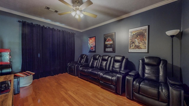 7640 Merion Dr, Beaumont, TX 77707 - cinema room featuring a ceiling fan, wood finished floors, and crown molding